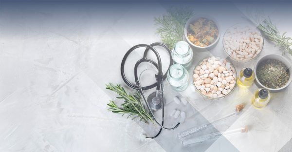 pills, herbs and medical supplies on white marble background indicating the idea of functional medicine marketing